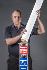 man holding ISOLUX arsenic removal cartridge