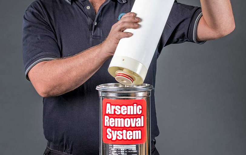 man holding isolux arsenic removal media